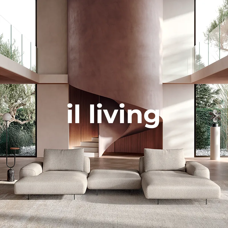 Soggiorno a doppia altezza con divani modulari grigi, scala a chiocciola in tonalità terracotta e librerie a tutta parete